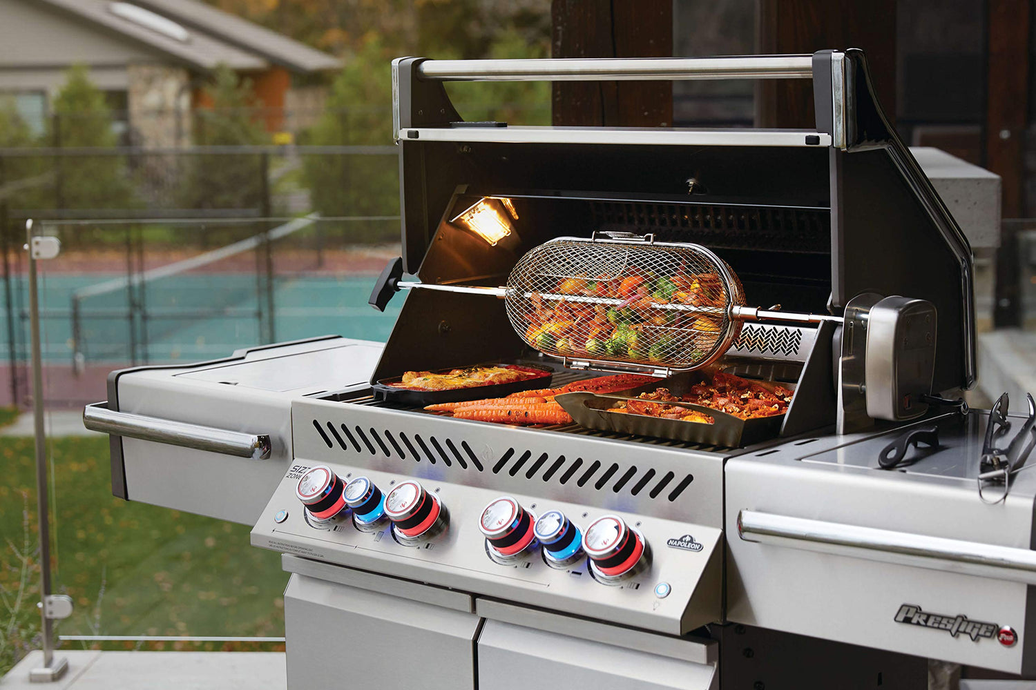 Napoleon Grill PRESTIGE® 500 grilling food on backyard patio